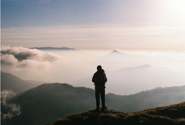 A person on the top of a mountain they have just hiked.