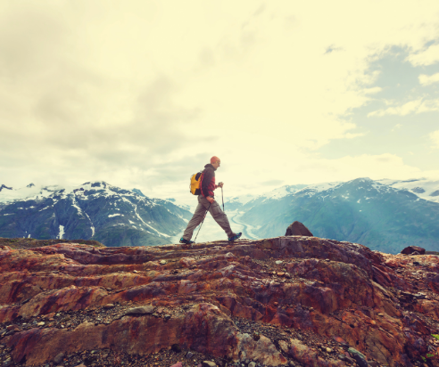 Man hiking across a mountain landscape