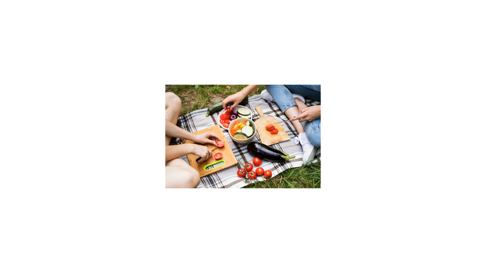 Two people cutting up vegetables