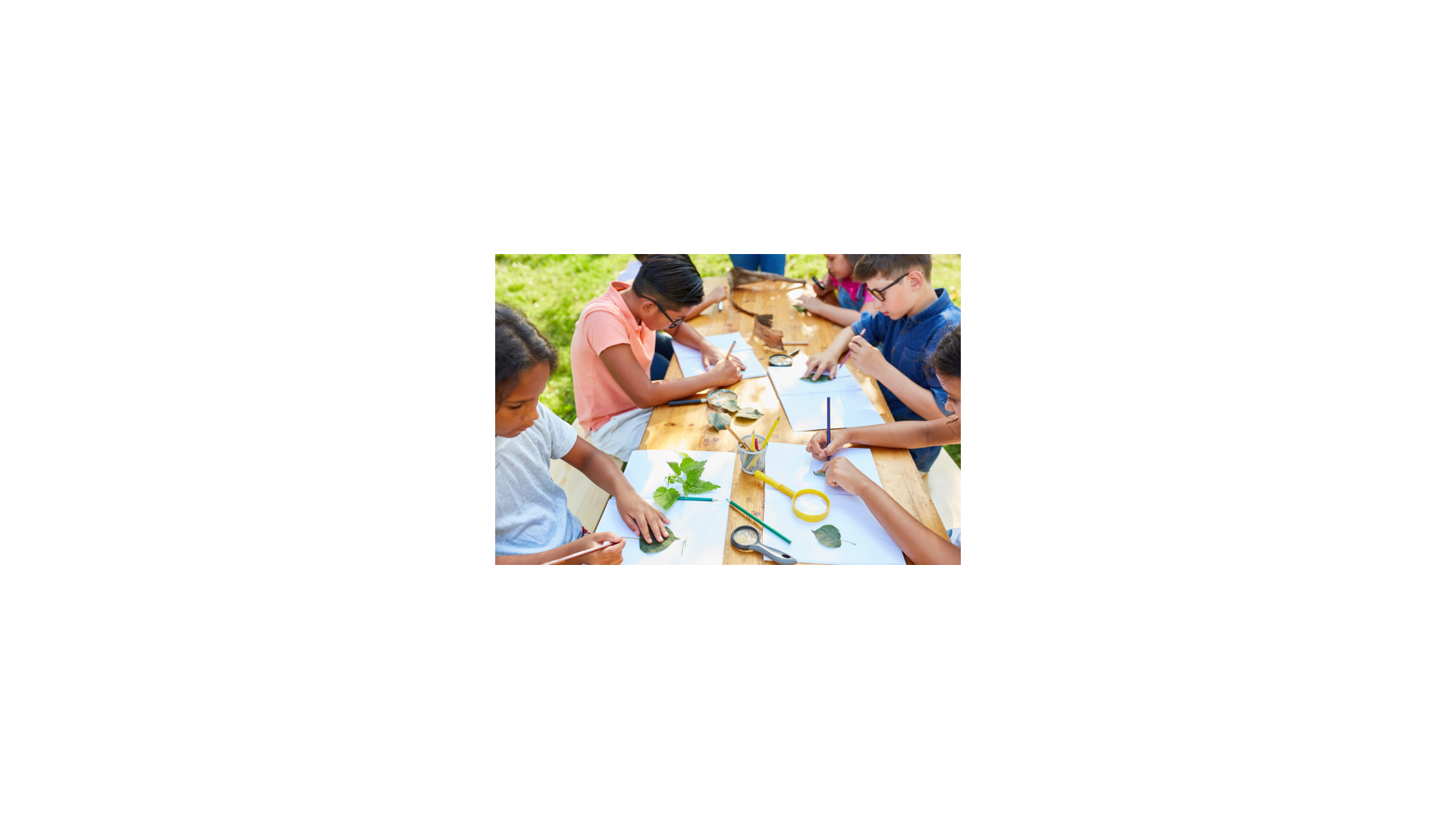 Kids sitting at a table doing activities