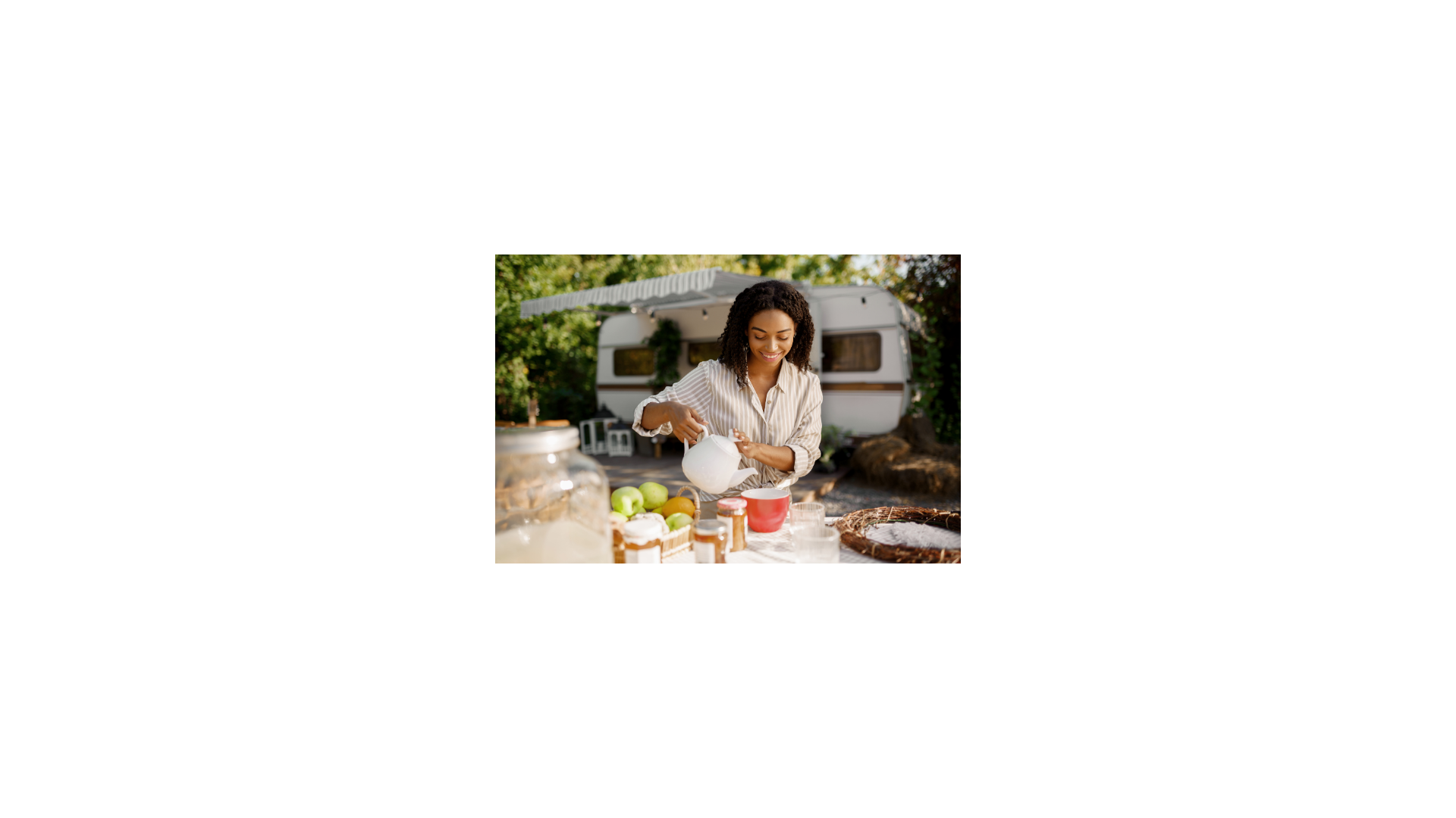 Lady pouring coffee into a mug on a table with breakfast foods