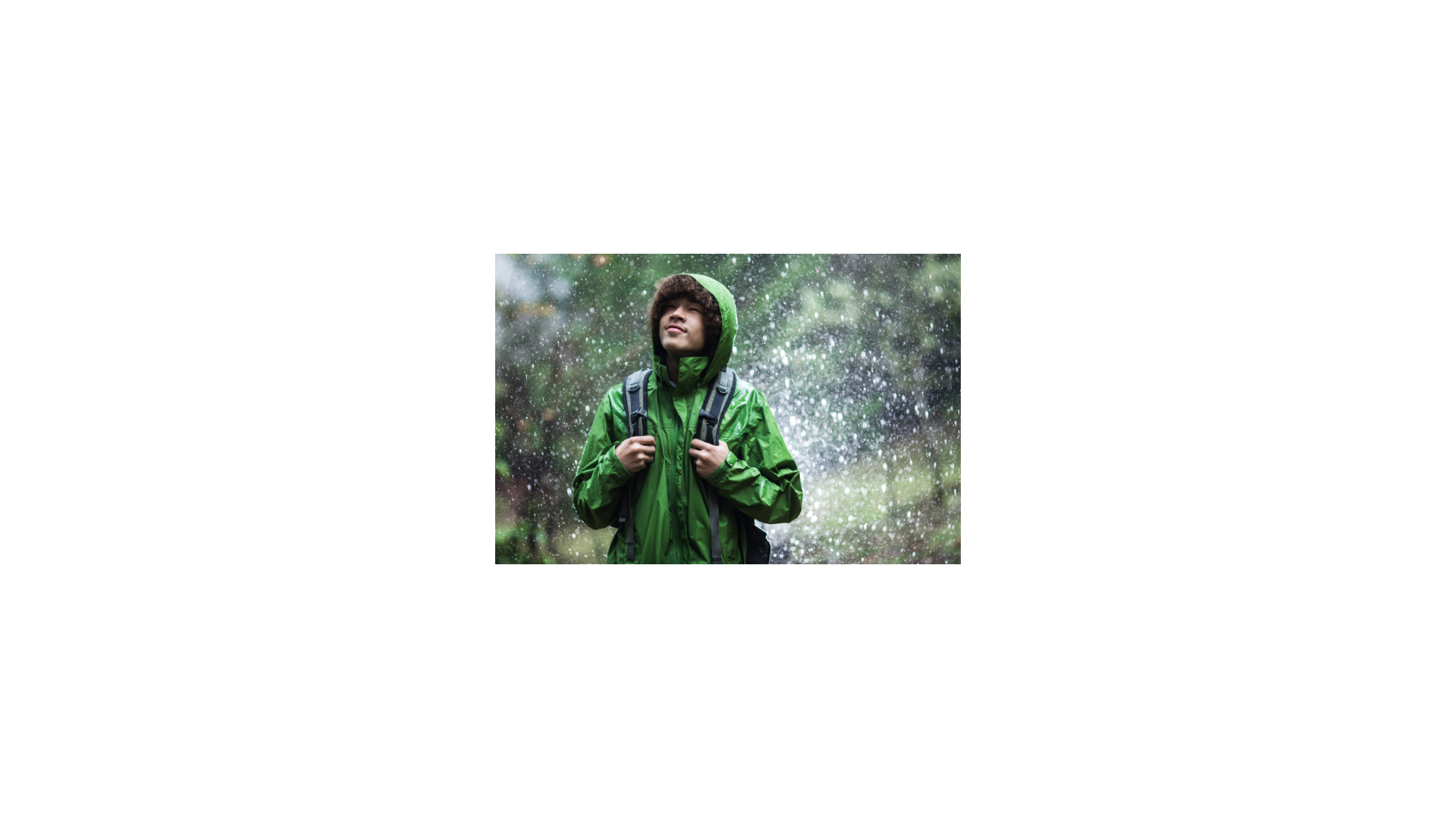 Man hiking in rain with waterproof jacket