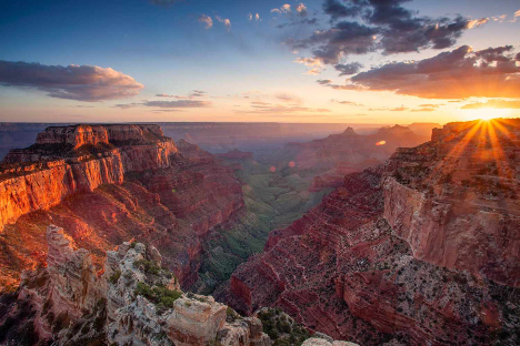 a view of a canyon with a sunset