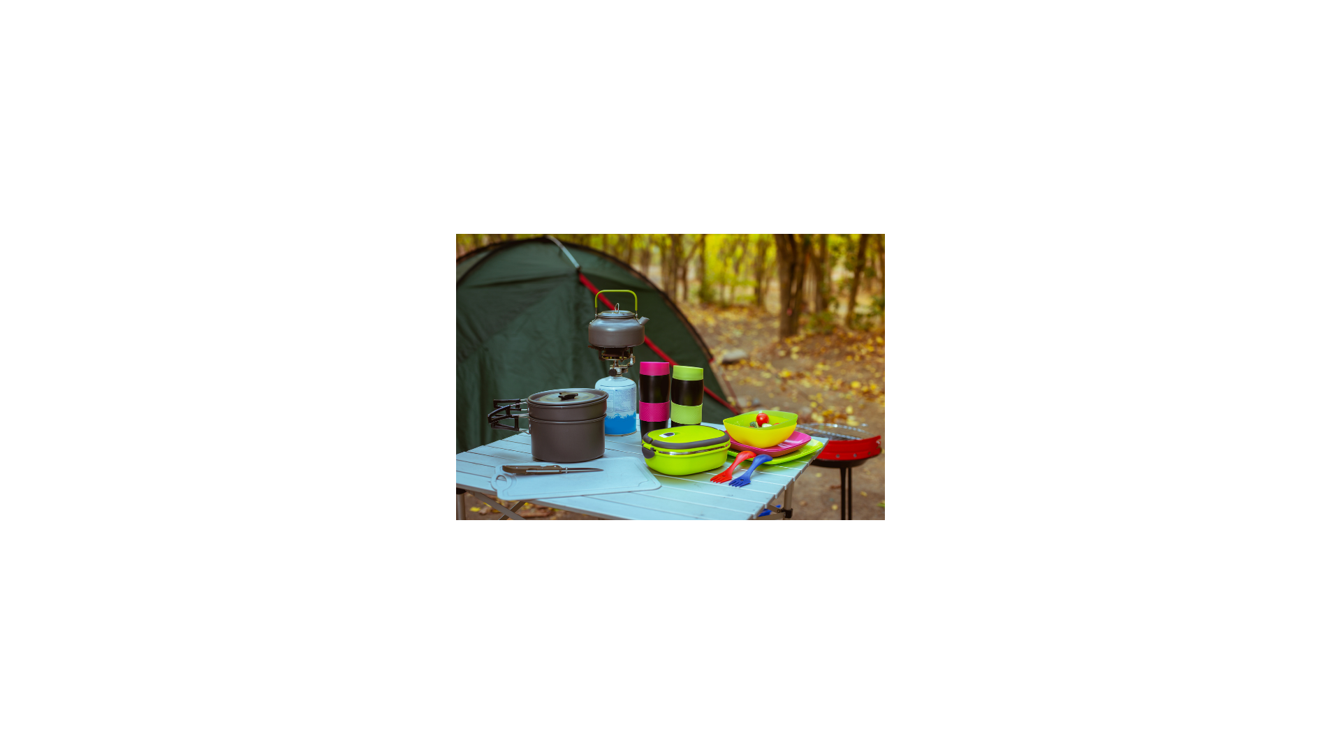 Camping cooking supplies sitting on a picnic table