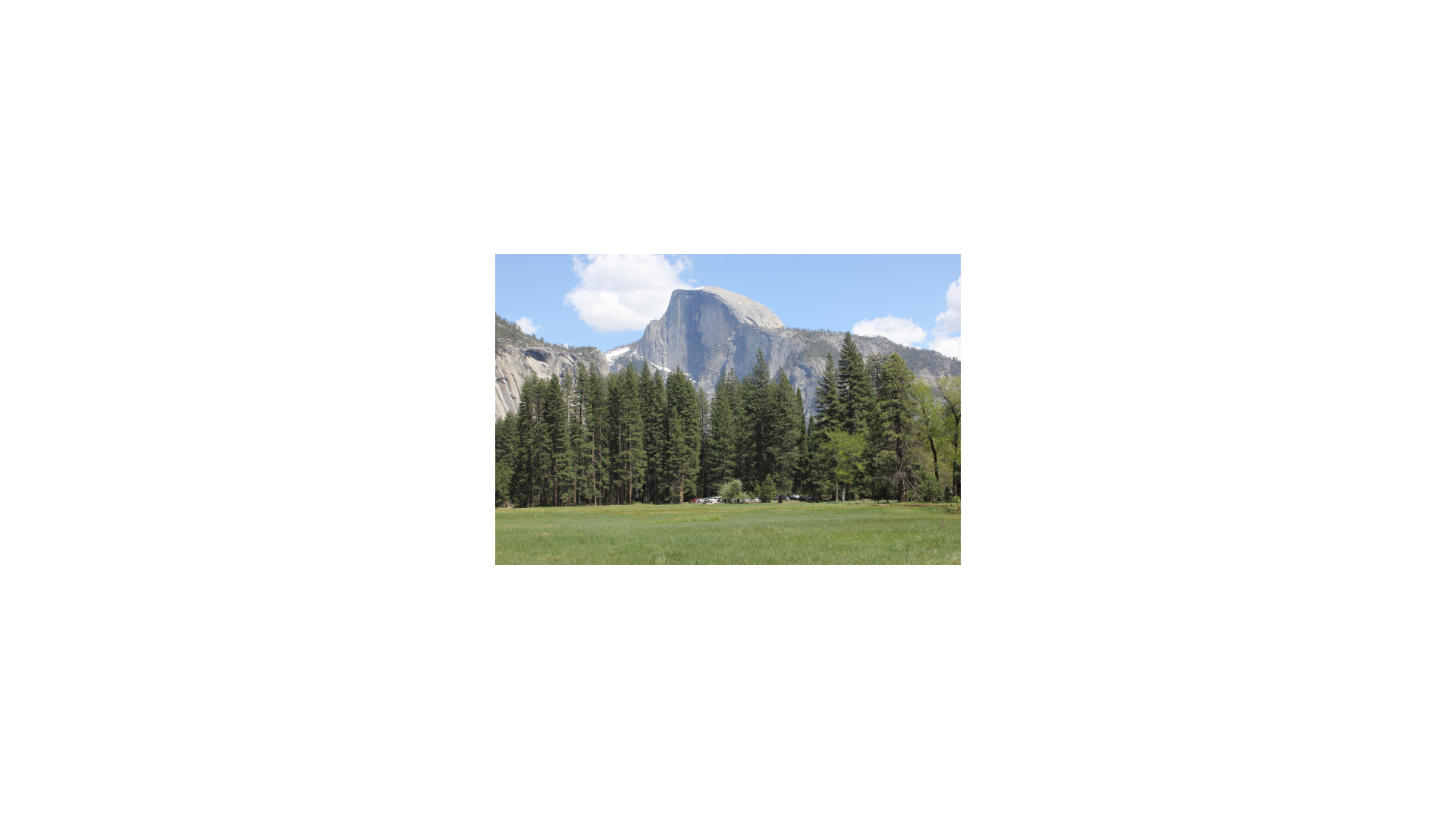 mountain with trees in front and valley in front of trees