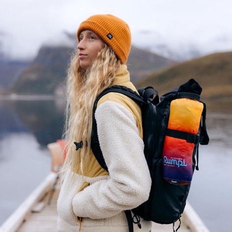 A person with a backpack on a dock