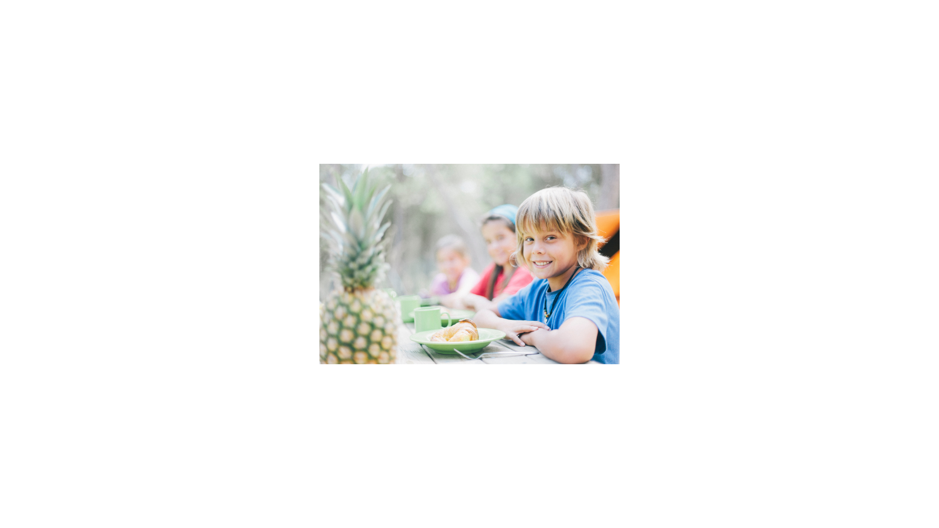 Kids sitting at a table eating breakfast